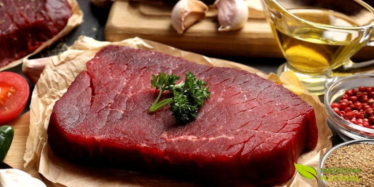 Bife suculento de carne vermelha grelhado sobre tábua de madeira. A carne vermelha contém gorduras saturadas mas também fornece proteínas de alta qualidade, ferro heme, zinco e vitamina B12. O problema não é a carne em si, mas o excesso. Prefira cortes magros e consuma com moderação (2-3 vezes/semana).