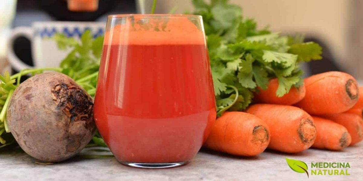 Suco vermelho vibrante de beterraba e cenoura, rico em nitratos que o corpo converte em óxido nítrico para melhorar a saúde cardiovascular. A cor intensa reflete a alta concentração de betalaínas e carotenoides, poderosos antioxidantes que combatem o estresse oxidativo e promovem a vitalidade celular.